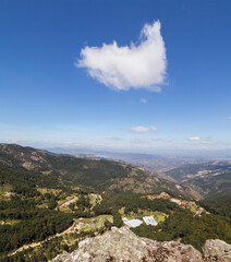 Beautiful shot of high mountains and hills covered by greenery on a sunny day