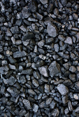 Pile of coal from mine deposit of black mineral stones