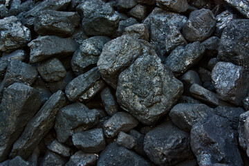 Pile of coal from mine deposit of black mineral stones