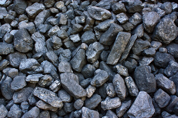 Pile of coal from mine deposit of black mineral stones
