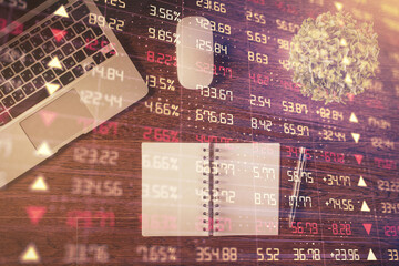 Stock market graph and top view computer on the table background. Double exposure. Concept of financial education.