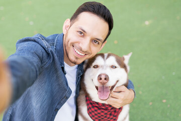 Adult man taking a photo with his dog buddy