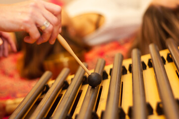 reiki session and sound harmonization with Tibetan bowls with hands giving relaxation to the woman in the zen space