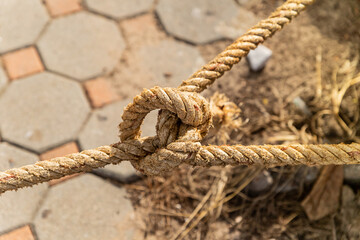 nautical knot from old and weathered rope closeup part of a mooring cable