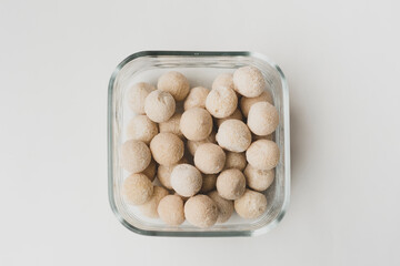 balls of kashk in a square glass bowl