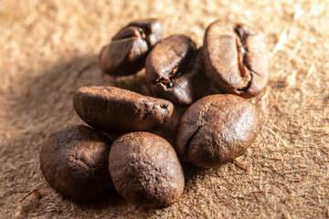selective focus of raosted grains brazilian coffee on wooden background in Brazil