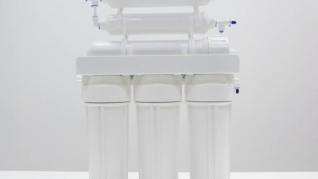 Zooming on white plastic reverse osmosis water filter with membranes