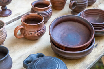 rustic pottery clay traditional set cup and plate set counter at a village fair
