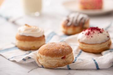 Beautiful Donuts arranged on a table with a glass of milk for recipe page or magazine editorial