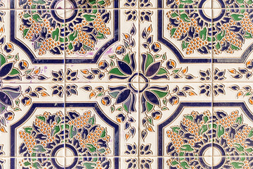 pattern of multicoloured tiles with painted flowers