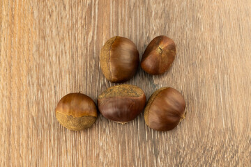 heap brown chestnut peeled on a wooden board street snack in europe