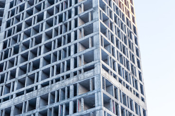 Fototapeta premium tall gray cement building foundation for a residential building close-up against the sky