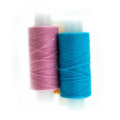 pair of vertical spools of thread blue and orange embroidery material