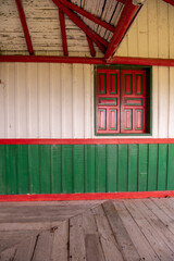 
old wooden house in green and roo color