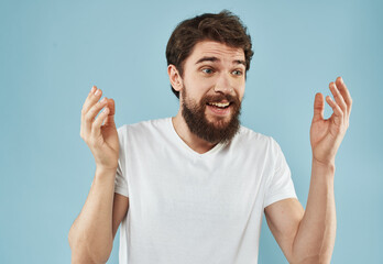 Handsome man with beard on blue background white t-shirt portrait cropped view