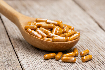 spoon full of turmeric herbal powder capsule pills