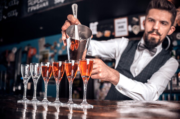 Bartender makes a cocktail at the alehouse