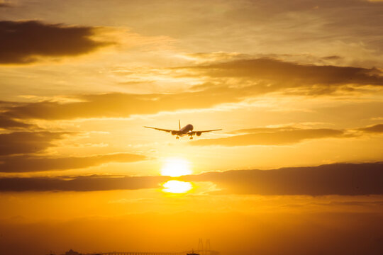 aircraft landing with sun set background