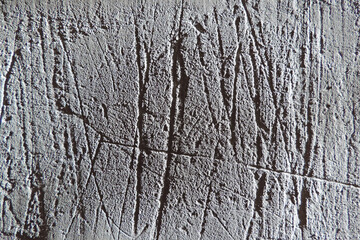 Obraz premium Grungy texture of gray plaster made from mixture of concrete, deep scratches, cement and small stones. wall texture background.