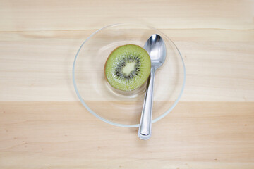 Half the kiwi placed in a clear plate.
