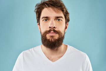 Obraz premium Bearded man emotions facial expression gestures hands close-up blue background