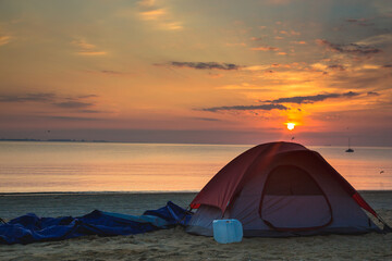 Tent on the beach at sunset