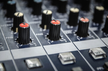 Audio mixer console and professional sound mixing with buttons and sliders.
