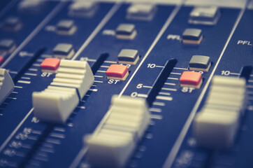 Audio mixer console and professional sound mixing with buttons and sliders.