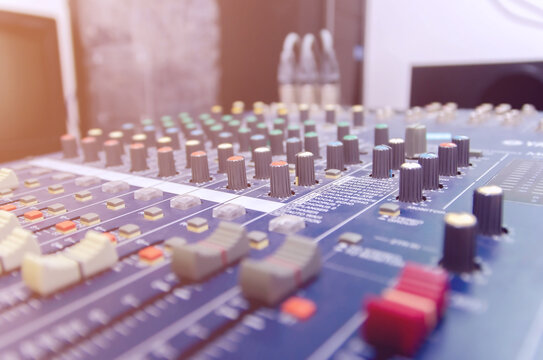 Audio mixer console and professional sound mixing with buttons and sliders.