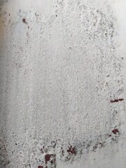 wall texture- coarse concrete with white paint and red dots here and there