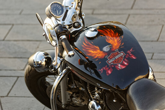 Harley Davidson Chopper dashboard and fuel tank painted with burning eagle and Turkish Flag. Protection helmet with Harley Davidson name hanged on the grip. Istanbul / Turkey - November 10 2019.