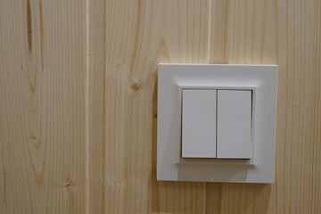 Fototapeta na wymiar Light switch. Double. On the wood wall.