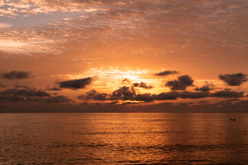 Natural beautiful sunrise over sea and horizon in the morning. Sunlight reflected on calm waves. Seascape under scenic colorful sky sunrise