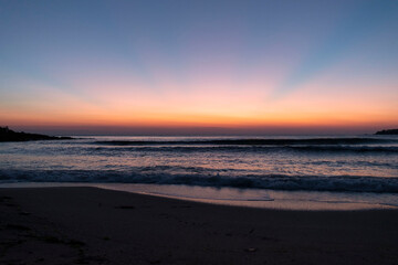 Natural beautiful sunrise over sea and horizon in the morning. Sunlight reflected on calm waves. Seascape under scenic colorful sky sunrise