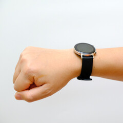 Fototapeta premium Human hand wearing smart watch with blank screen, white background cutout. modern digital gadget with empty display, copy space for text, Wearable gadget concept