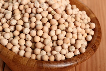 Whole yellow peas in wooden bowl