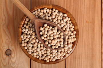 Whole yellow peas in wooden bowl