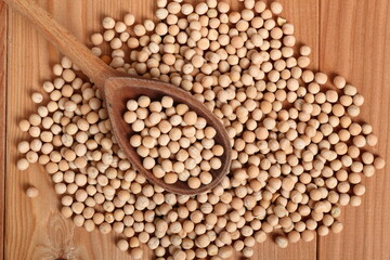 Whole yellow peas in wooden spoon