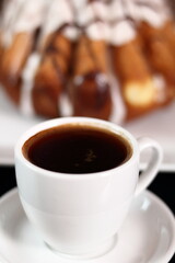 Coffee cup and cake with sugar icing