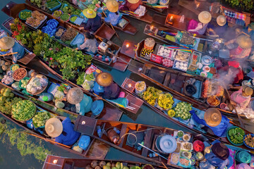 Damnoen Saduak Floating Market or Amphawa. Local people sell fruits, traditional food on boats in canal, Ratchaburi District, Thailand. Famous Asian tourist attraction destination. Festival in Asia.