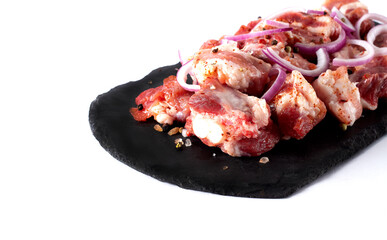 Pork, sliced, raw, with spices, horizontal, on a white plate, copy spaspce,