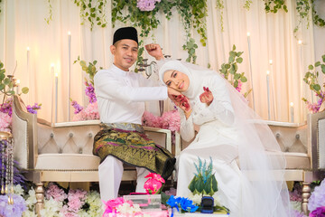 A muslim couple getting solemnization . Malay Traditional Wedding. In a islamic wedding the most...