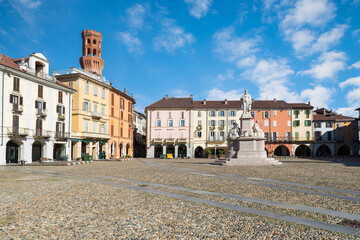 Beautiful square in an old city in Italy. Historic center of Vercelli. Square Cavour with the monument to Cavour of 1864 and the Angel tower (14th-17th century), symbol of the city 