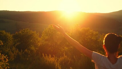 back view traveler raising hands enjoy freedom vacation in highlands beautiful mountains landscape sunse