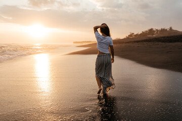 Happy Carefree Woman Enjoying Beautiful Sunset on the Beach