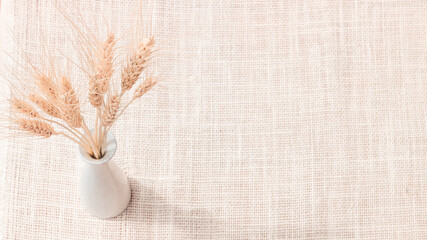 Wheat on sack cloth background with copy space