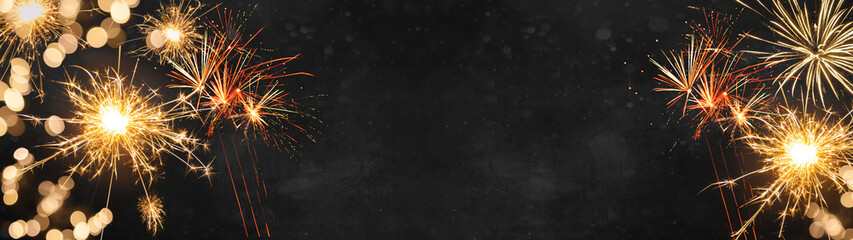 Silvester Party / New Year background banner panorama - Golden Firework and sparklers at dark black...