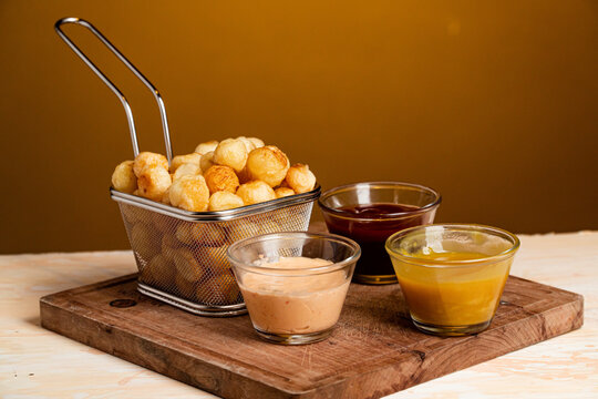 Closeup shot of Noisette potatoes with various sauces shot of
