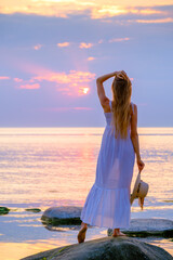 Slim woman in summer dress at seaside