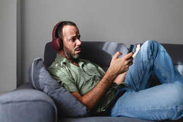 Obraz premium disappointed man looking at sports betting results on mobile phone